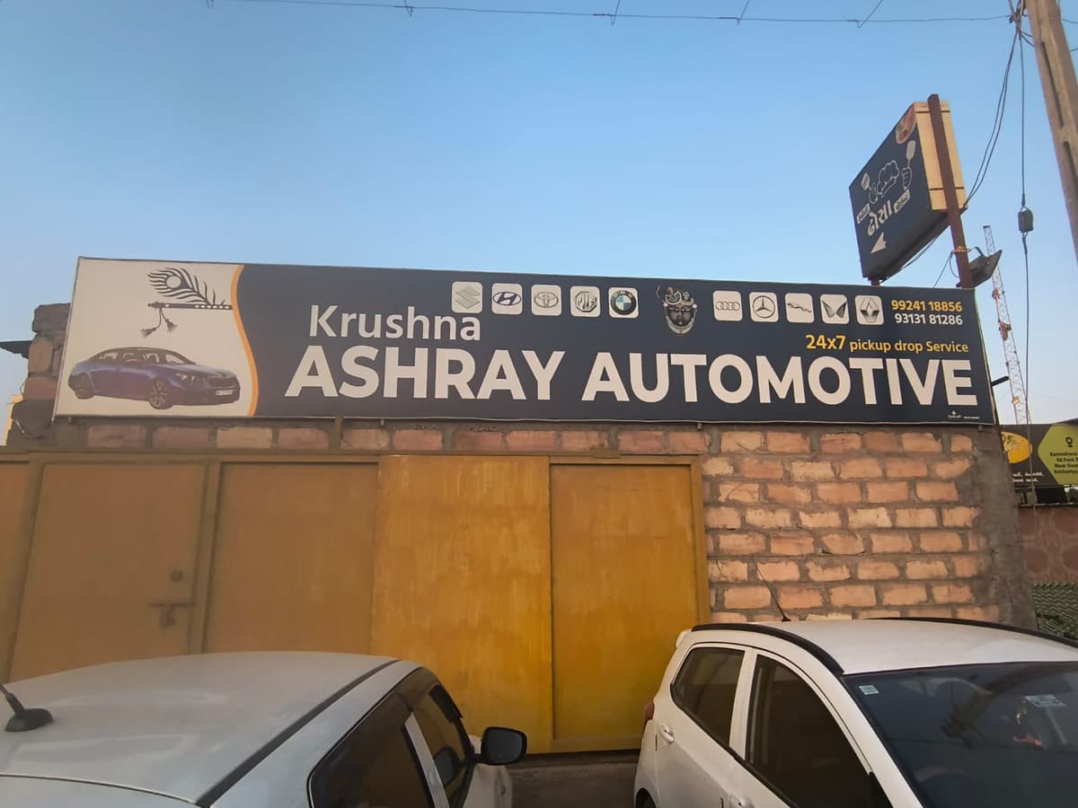 Krushna Ashray Automotive shop front with signboard showing all car brands serviced in Kothariya Rajkot